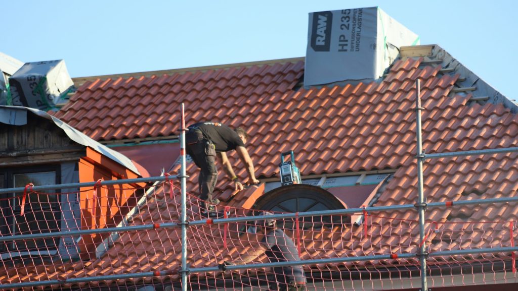 A man on a roof working on a roof